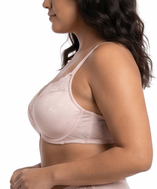 Woman wearing light pink comfort bra in a white background.