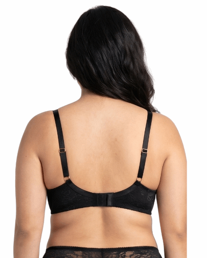 Woman wearing a black lace bra on a white background