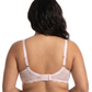 Woman wearing light pink comfort bra in a white background.