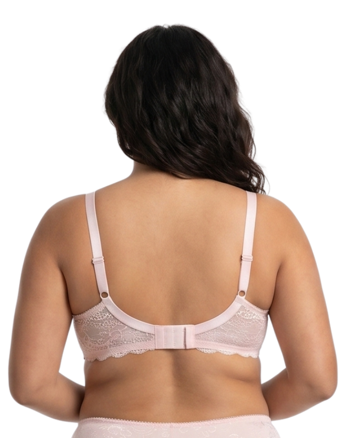 Woman wearing light pink comfort bra in a white background.