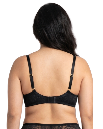 Woman wearing a black lace bra on a white background