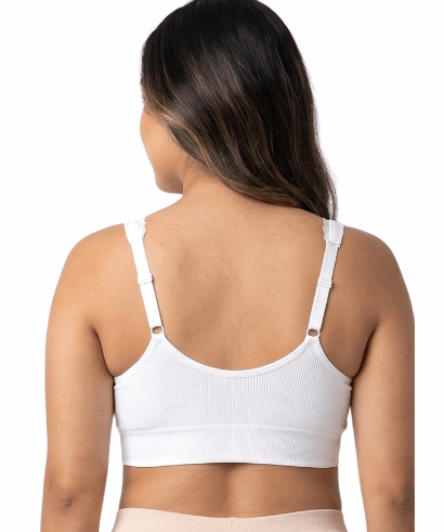 Woman wearing a white comfort bra on a white background