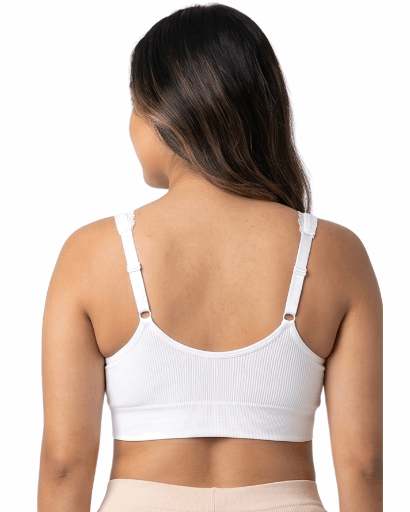 Woman wearing a white comfort bra on a white background