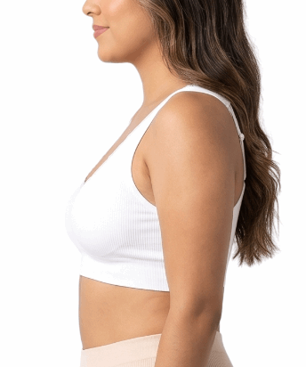 Woman wearing a white comfort bra on a white background