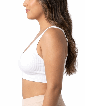 Woman wearing a white comfort bra on a white background