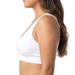 Woman wearing a white comfort bra on a white background