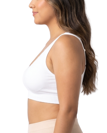 Woman wearing a white comfort bra on a white background
