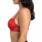 Woman wearing a red lace bra on a white background