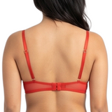 Woman wearing a red lace bra on a white background