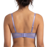 Person wearing a lavender lingerie set on a white background