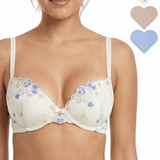 Woman wearing a floral embroidered bra with color swatches above her head.