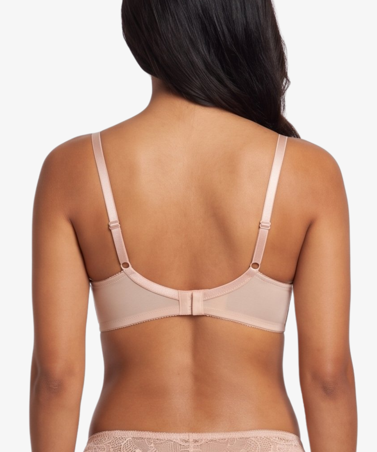 A woman shown from the back wearing a matching nude-beige bra and panty set with lace trim, against a plain light gray studio background.