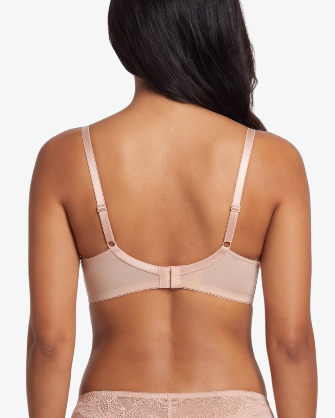 A woman shown from the back wearing a matching nude-beige bra and panty set with lace trim, against a plain light gray studio background.