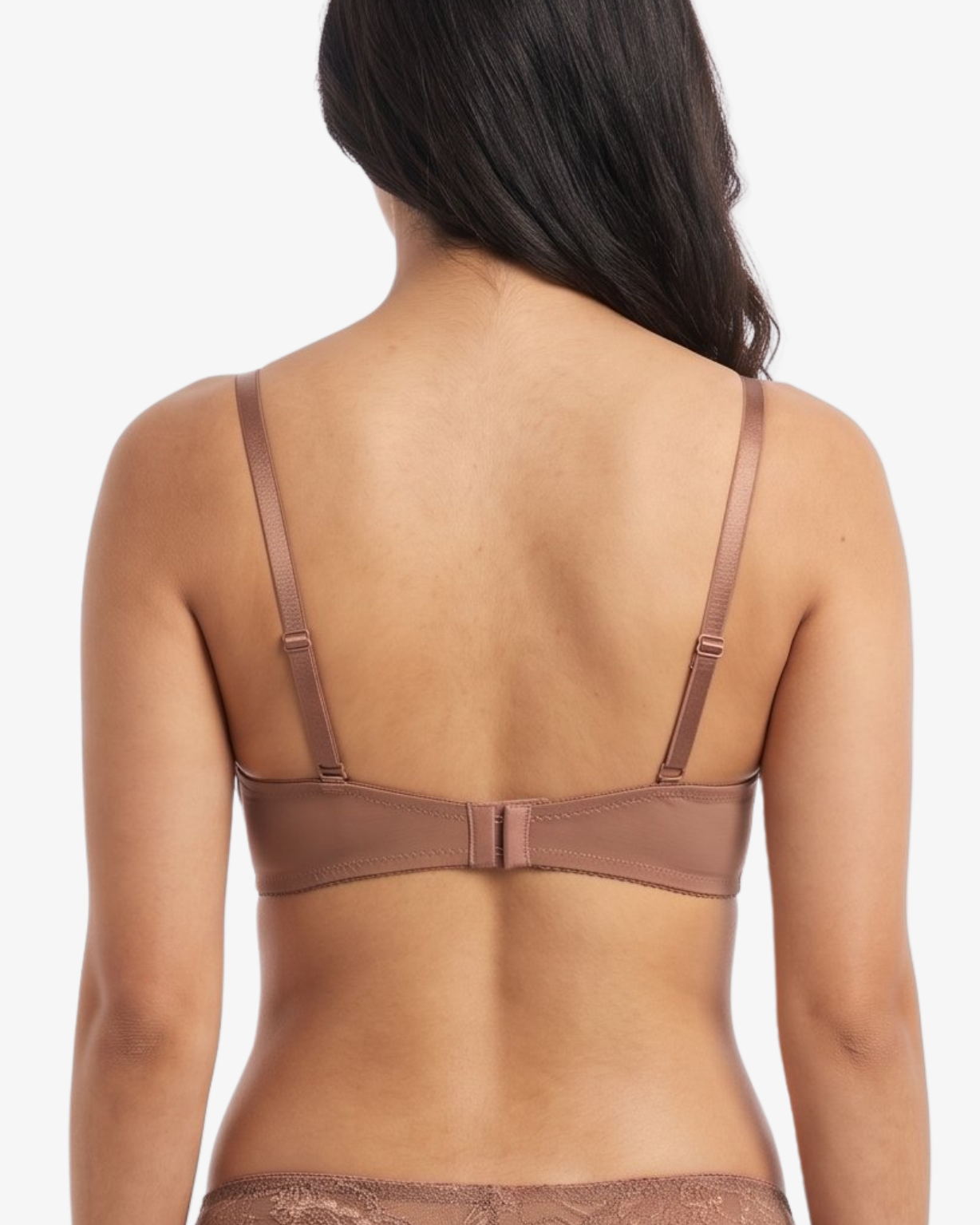 Rear view of a model wearing a matching nude-brown lace bra and panty set against a plain light gray studio background.