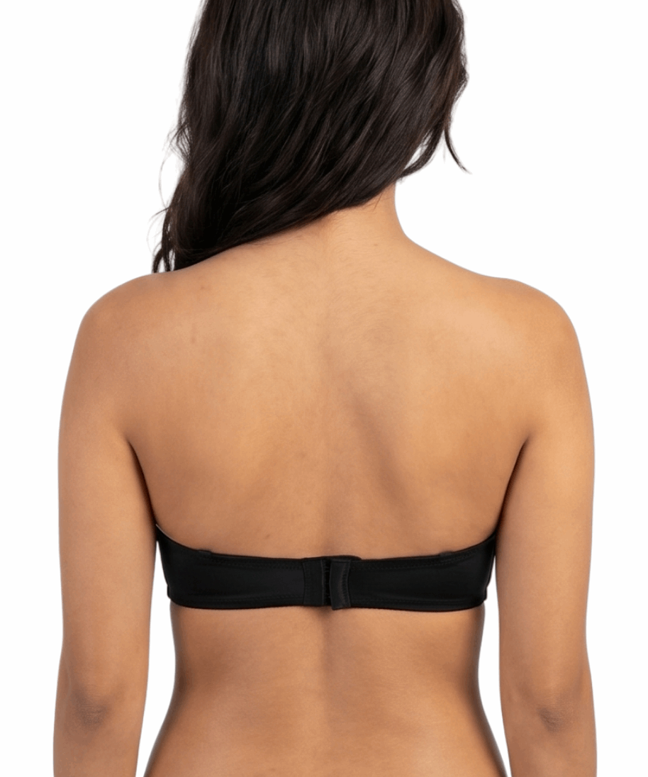 Woman wearing a black strapless bra on a white background