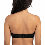 Woman wearing a black strapless bra on a white background