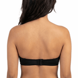 Woman wearing a black strapless bra on a white background