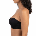 Woman wearing a black strapless bra on a white background