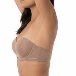 Woman wearing a mocha strapless bra on a white background