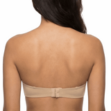 Woman wearing a nude strapless bra on a white background