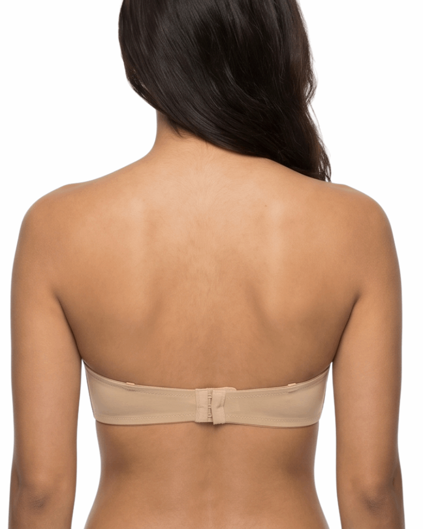 Woman wearing a nude strapless bra on a white background