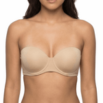 Woman wearing a nude strapless bra on a white background