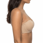 Woman wearing a nude strapless bra on a white background