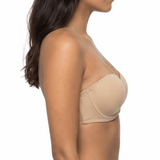 Woman wearing a nude strapless bra on a white background