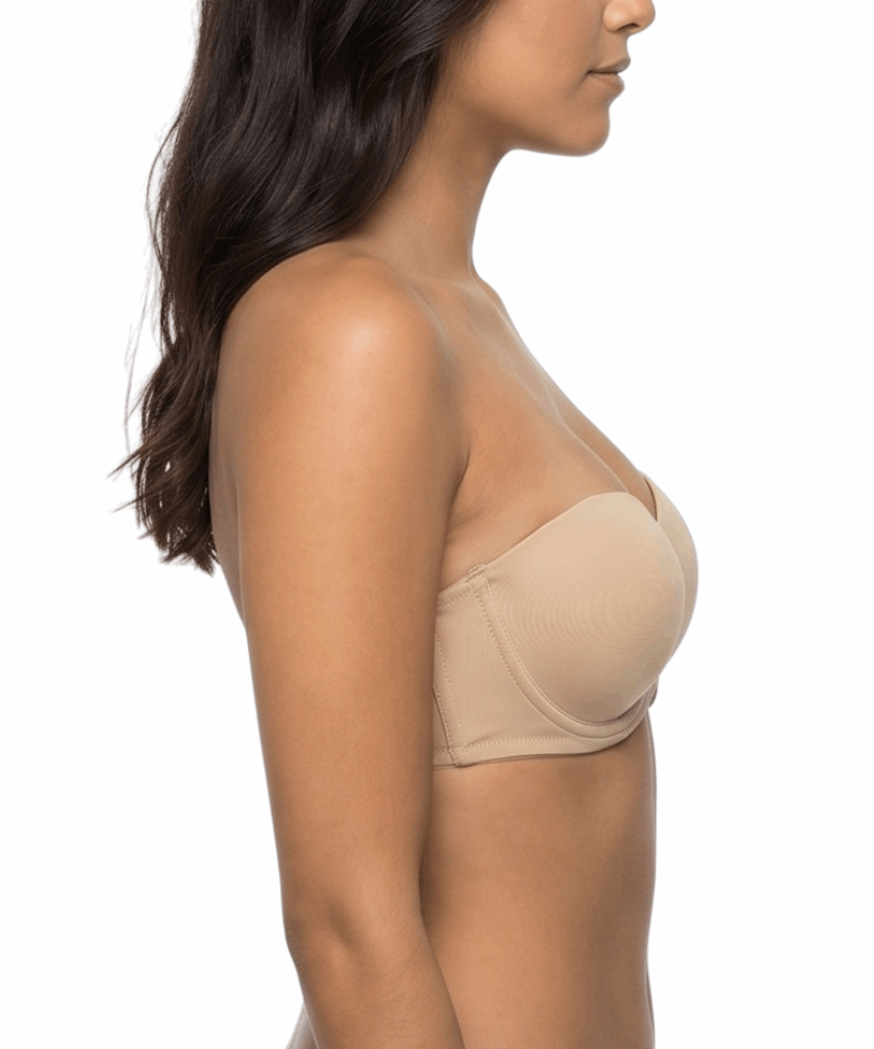 Woman wearing a nude strapless bra on a white background