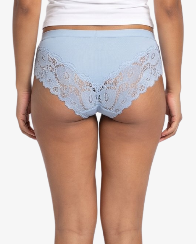 A woman modeling a light blue high-waisted briefs against a plain light gray background.