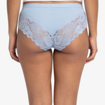 A woman modeling a light blue high-waisted briefs against a plain light gray background.