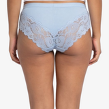 A woman modeling a light blue high-waisted briefs against a plain light gray background.