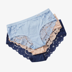 A three-pack of women's lace-trimmed briefs in light blue, beige, and navy, arranged in a fan shape on a light gray background.
