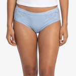 A woman modeling a  light blue high-waisted briefs against a plain light gray background.