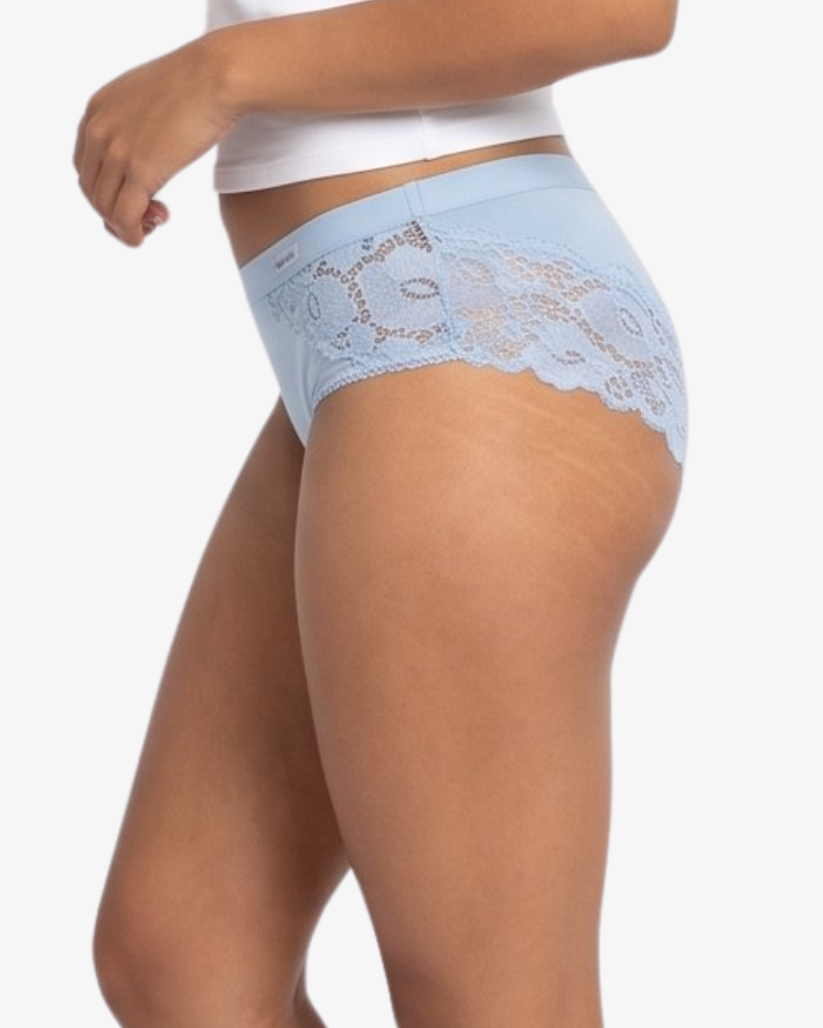 A woman modeling a  light blue high-waisted briefs against a plain light gray background.