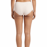 Woman wearing a beige panty on a white background
