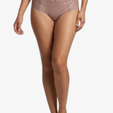 A model wearing dusty rose pink lace panties, shown from the waist down against a plain white background.