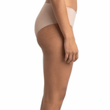 Woman wearing a beige shapewear garment on a white background