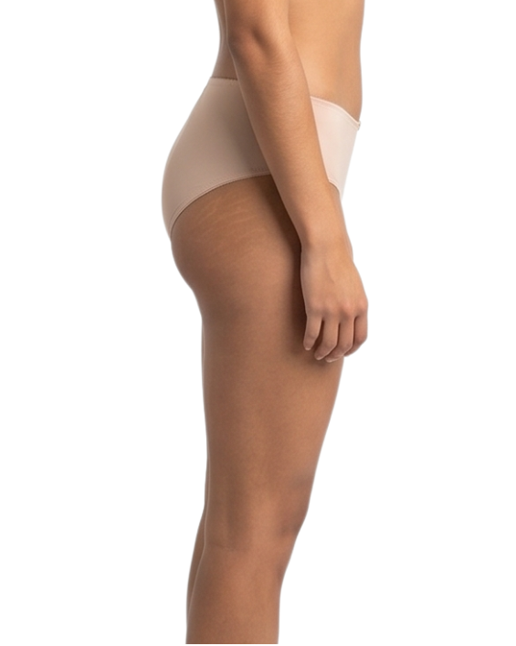 Woman wearing a beige shapewear garment on a white background