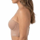 Woman wearing a beige longline bra on a white background