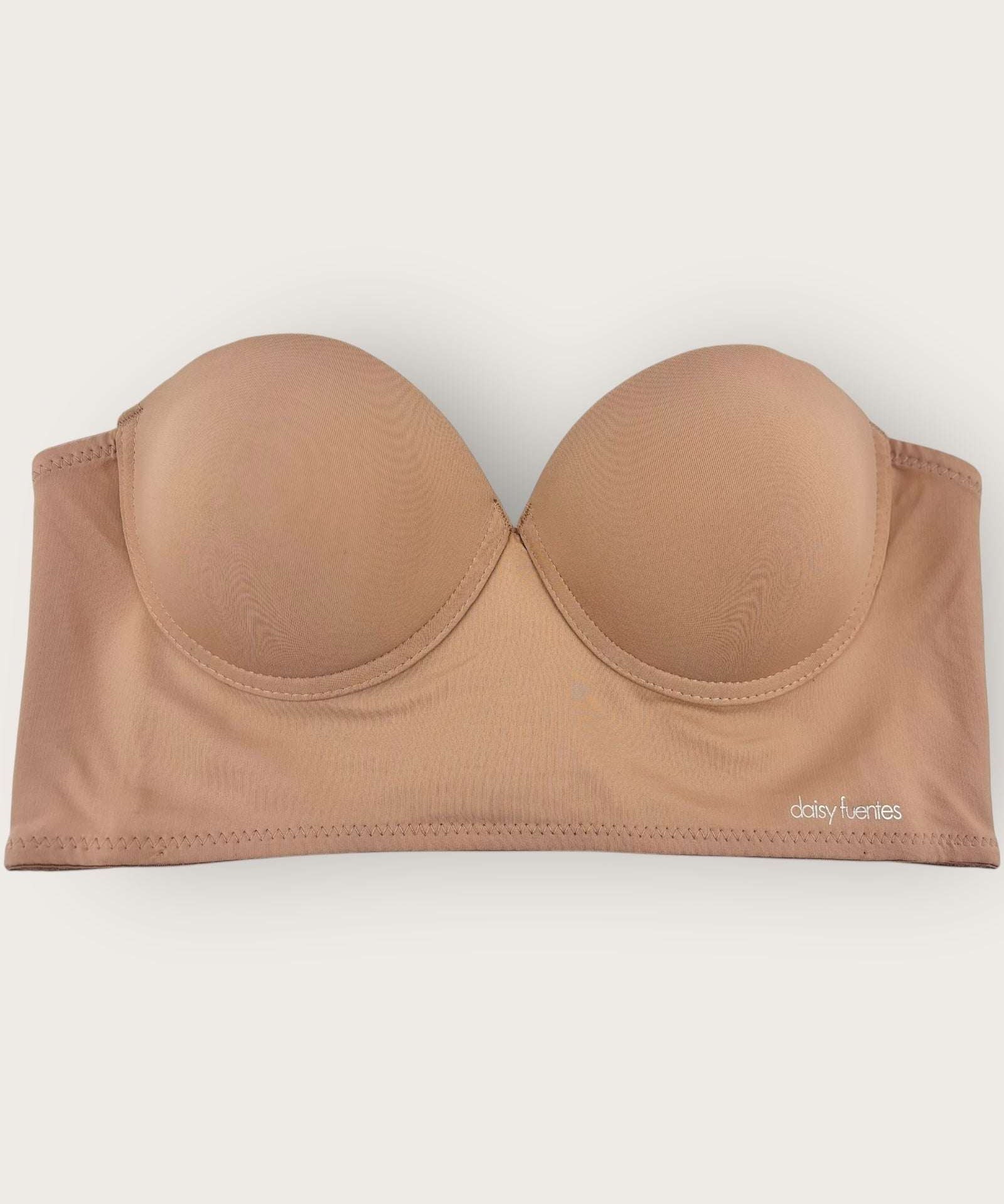 Beige strapless bra on a white background