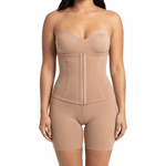Woman wearing a beige shapewear bodysuit on a white background