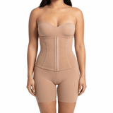 Woman wearing a beige shapewear bodysuit on a white background