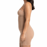 Woman wearing a beige shapewear garment on a white background