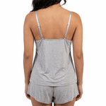 Woman wearing a gray tank top and shorts set on a white background