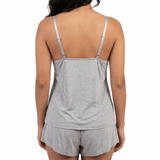 Woman wearing a gray tank top and shorts set on a white background