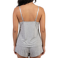 Woman wearing a gray tank top and shorts set on a white background