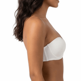Woman wearing a white strapless bra on a white background