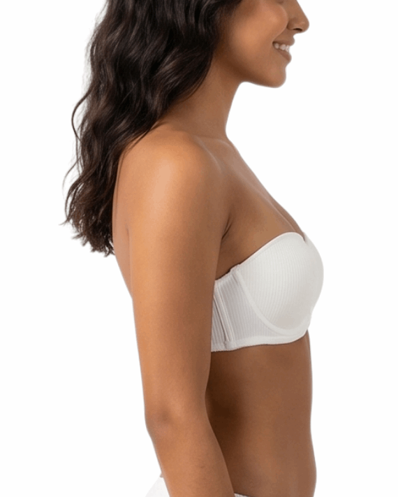 Woman wearing a white strapless bra on a white background