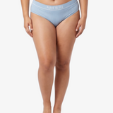A woman modeling a pair of light blue bikinis against a plain white studio background. The underwear has a white elastic waistband with the brand name 'PARIS BLUES' printed in white.